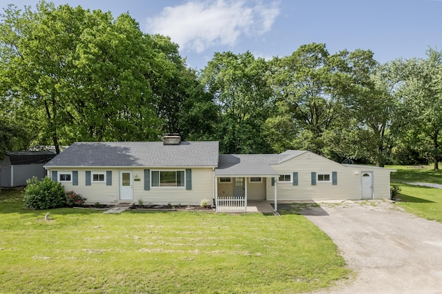 1366 Dyer Rd, Grove City, OH 43123 - ranch-style house featuring asphalt driveway, a front lawn, a chimney, view of wooded area, and roof with shingles