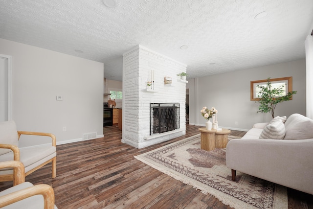 1366 Dyer Rd, Grove City, OH 43123 - living room featuring wood finished floors, baseboards, a textured ceiling, and a fireplace