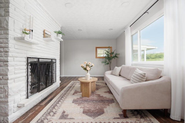 1366 Dyer Rd, Grove City, OH 43123 - living area featuring a textured ceiling, wood finished floors, baseboards, and a large fireplace