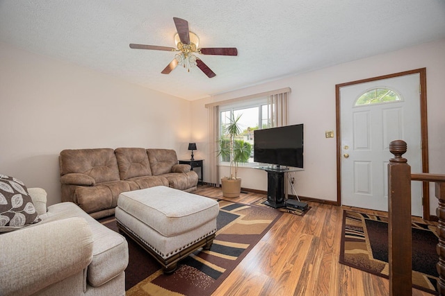 5965 Lucky Charm Dr, Galloway, OH 43119 - living area featuring wood finished floors, healthy amount of natural light, a ceiling fan, baseboards, and a textured ceiling