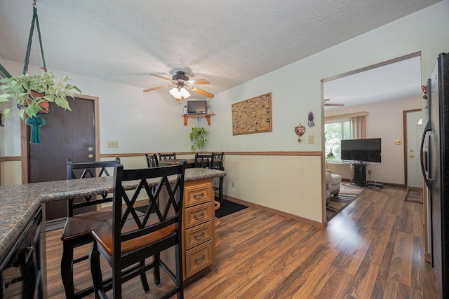 5965 Lucky Charm Dr, Galloway, OH 43119 - dining room with wood finished floors, a ceiling fan, a textured ceiling, and baseboards