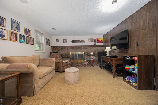 5965 Lucky Charm Dr, Galloway, OH 43119 - living room featuring light carpet, wooden walls, a textured ceiling, and a fireplace