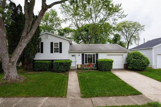 5965 Lucky Charm Dr, Galloway, OH 43119 - tri-level home with a garage, brick siding, concrete driveway, and a front yard