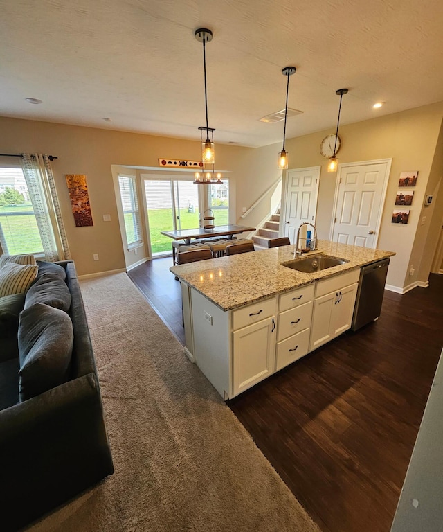 7540 Twisted Bark Dr, Canal Winchester, OH 43110 - kitchen with a sink, stainless steel dishwasher, open floor plan, a center island with sink, and baseboards