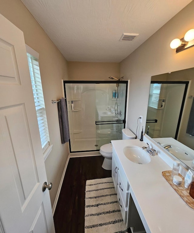 7540 Twisted Bark Dr, Canal Winchester, OH 43110 - full bathroom featuring a shower stall, toilet, wood finished floors, vanity, and baseboards