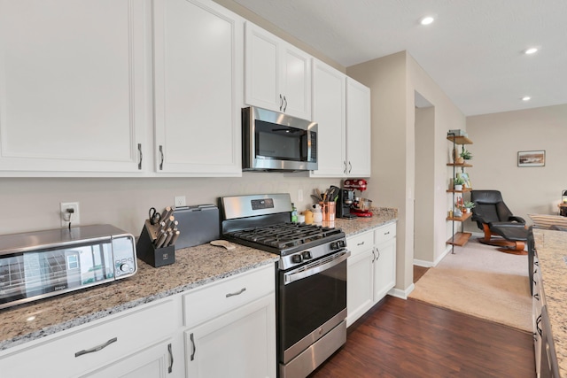 7540 Twisted Bark Dr, Canal Winchester, OH 43110 - kitchen with appliances with stainless steel finishes, white cabinetry, dark wood-style floors, recessed lighting, and light stone countertops