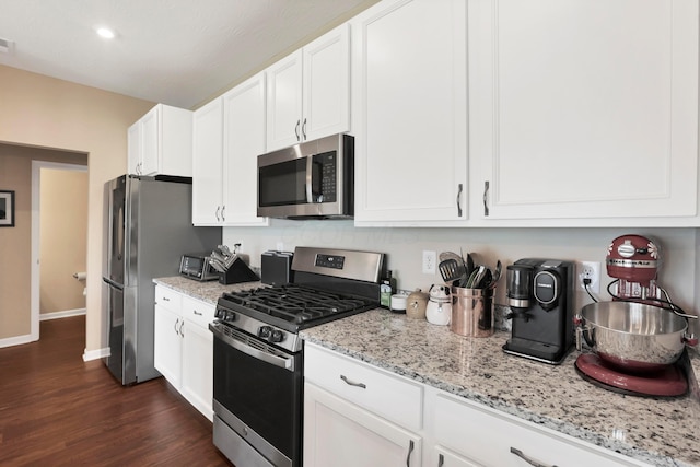 7540 Twisted Bark Dr, Canal Winchester, OH 43110 - kitchen featuring stainless steel appliances, white cabinets, dark wood finished floors, light stone countertops, and recessed lighting