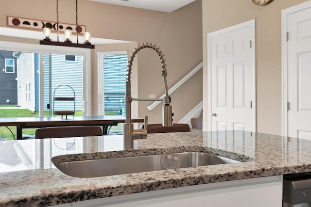7540 Twisted Bark Dr, Canal Winchester, OH 43110 - kitchen with light stone countertops, hanging light fixtures, and a chandelier