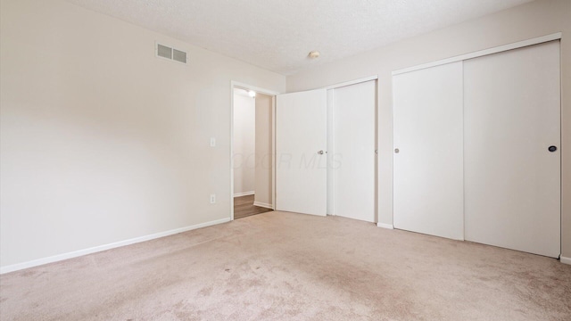 6706 Axtel Dr Unit 7A, Canal Winchester, OH 43110 - unfurnished bedroom with two closets, carpet flooring, and baseboards