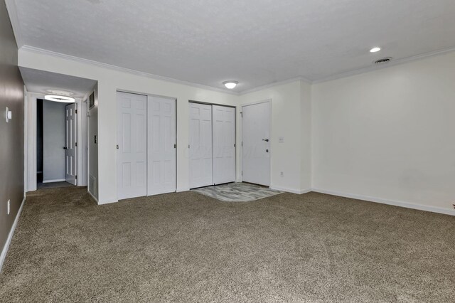 625 Country Club Dr Unit E4, Newark, OH 43055 - unfurnished bedroom with carpet, two closets, crown molding, and baseboards