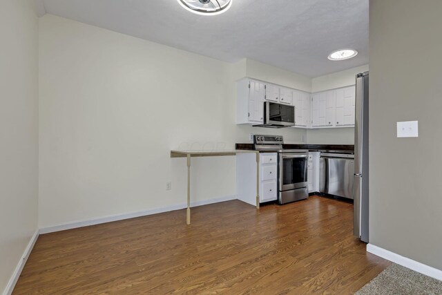 625 Country Club Dr Unit E4, Newark, OH 43055 - kitchen with stainless steel appliances, baseboards, white cabinetry, and dark wood-style floors