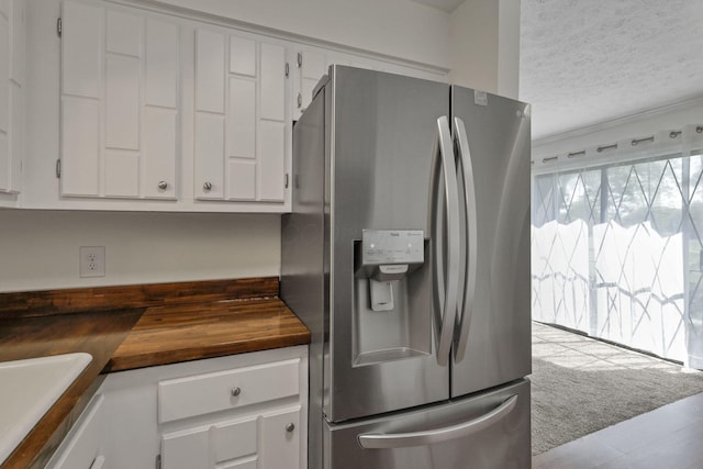 625 Country Club Dr Unit E4, Newark, OH 43055 - kitchen with stainless steel refrigerator with ice dispenser, butcher block counters, white cabinetry, a textured ceiling, and a sink