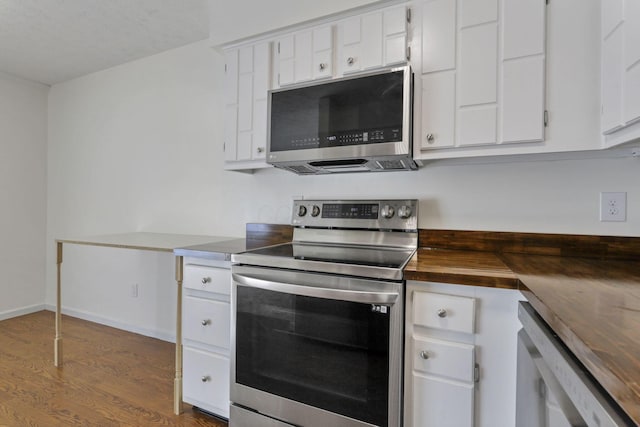 625 Country Club Dr Unit E4, Newark, OH 43055 - kitchen featuring stainless steel appliances, butcher block countertops, wood finished floors, and white cabinets