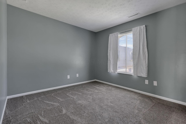 625 Country Club Dr Unit E4, Newark, OH 43055 - unfurnished room with dark colored carpet, a textured ceiling, and baseboards
