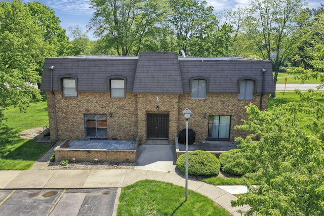 625 Country Club Dr Unit E4, Newark, OH 43055 - view of front of home featuring mansard roof, brick siding, and uncovered parking