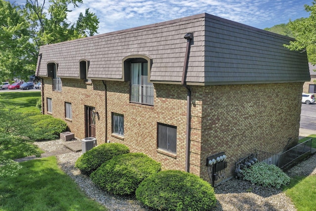625 Country Club Dr Unit E4, Newark, OH 43055 - view of side of home with brick siding, mansard roof, and central AC