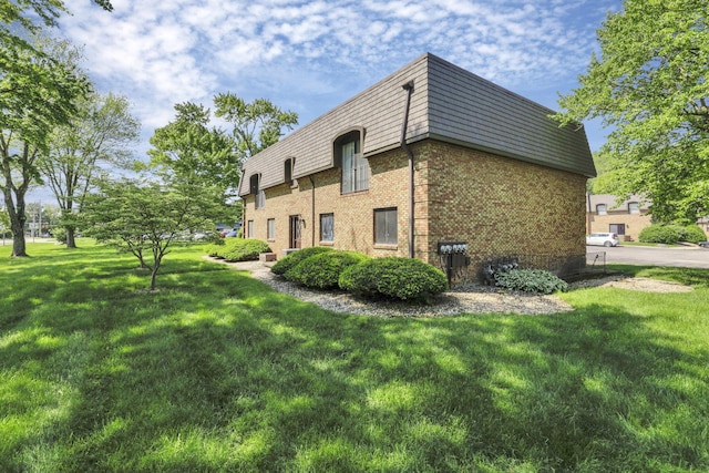 625 Country Club Dr Unit E4, Newark, OH 43055 - view of side of property with brick siding, a yard, and mansard roof
