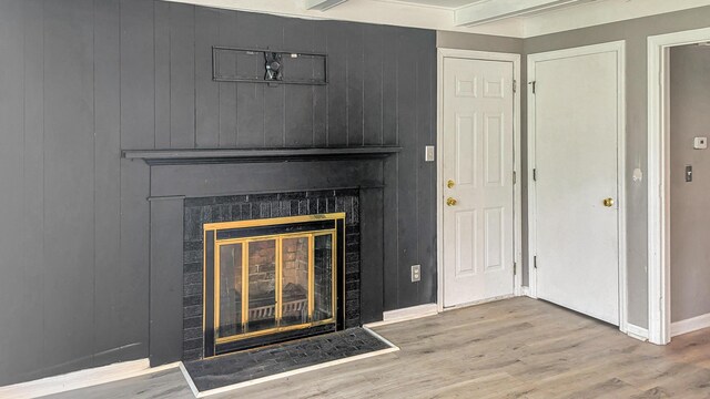 1236 Lindenwood Rd N, Columbus, OH 43229 - detailed view of baseboards, a glass covered fireplace, and wood finished floors