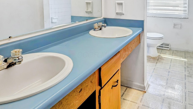 1236 Lindenwood Rd N, Columbus, OH 43229 - full bathroom featuring toilet, vanity, tile patterned flooring, and baseboards