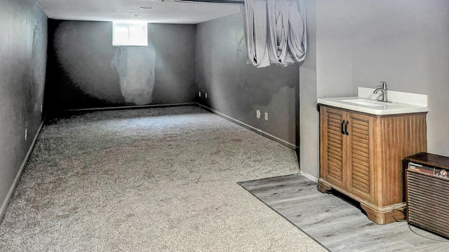 1236 Lindenwood Rd N, Columbus, OH 43229 - below grade area with a sink, baseboards, and light wood finished floors