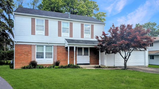1236 Lindenwood Rd N, Columbus, OH 43229 - view of front of property with a front yard, asphalt driveway, brick siding, and a garage