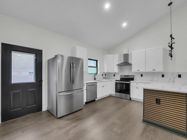 1292 Moundview Ave, Columbus, OH 43207 - kitchen featuring appliances with stainless steel finishes, wall chimney range hood, wood finished floors, a sink, and white cabinets