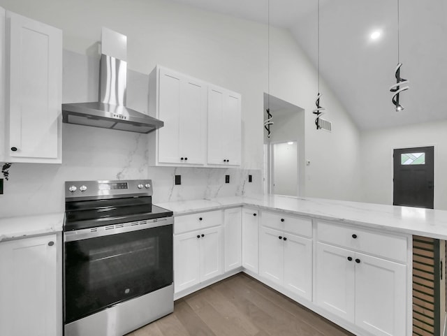 1292 Moundview Ave, Columbus, OH 43207 - kitchen with stainless steel electric range oven, wall chimney exhaust hood, vaulted ceiling, a peninsula, and white cabinetry