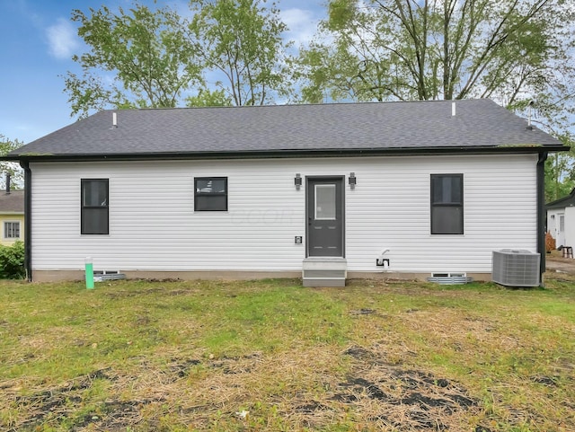 1292 Moundview Ave, Columbus, OH 43207 - rear view of property with entry steps, central AC, a yard, and a shingled roof