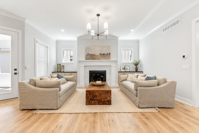 5599 Piatt Rd, Lewis Center, OH 43035 - living area featuring wood finished floors, ornamental molding, a chandelier, a tiled fireplace, and recessed lighting