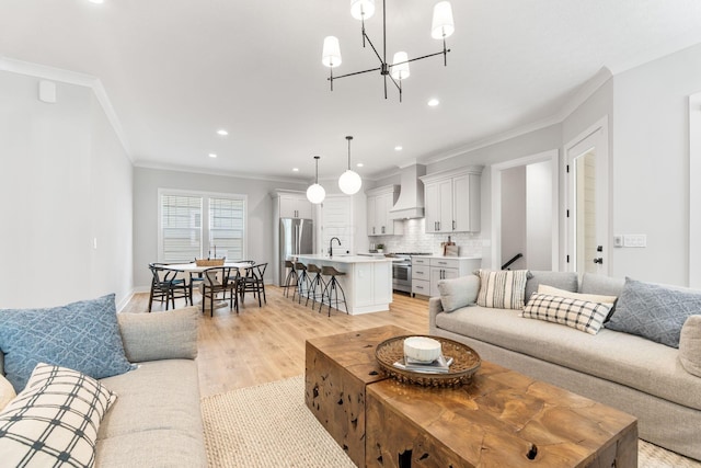5599 Piatt Rd, Lewis Center, OH 43035 - living room with ornamental molding, recessed lighting, light wood-style floors, and a chandelier