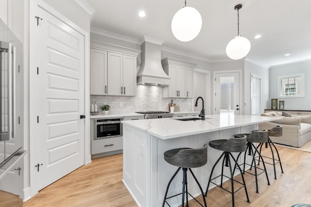 5599 Piatt Rd, Lewis Center, OH 43035 - kitchen featuring ornamental molding, premium range hood, tasteful backsplash, a kitchen breakfast bar, and open floor plan