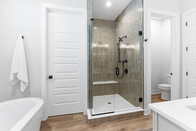 5599 Piatt Rd, Lewis Center, OH 43035 - full bath with a stall shower, a freestanding tub, vanity, wood finished floors, and recessed lighting