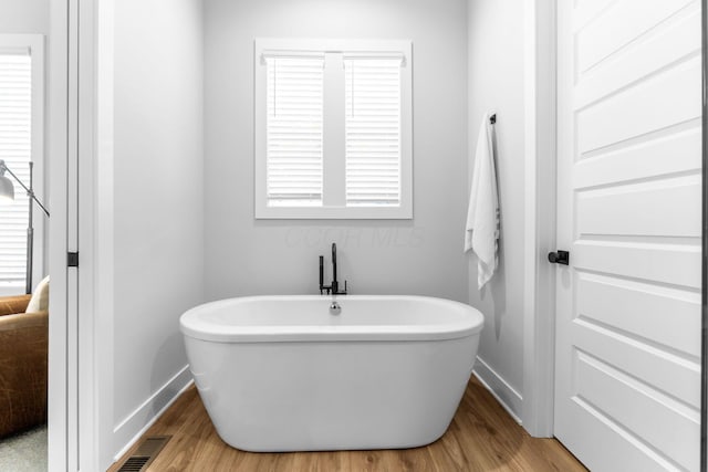 5599 Piatt Rd, Lewis Center, OH 43035 - full bathroom with a freestanding tub and wood finished floors