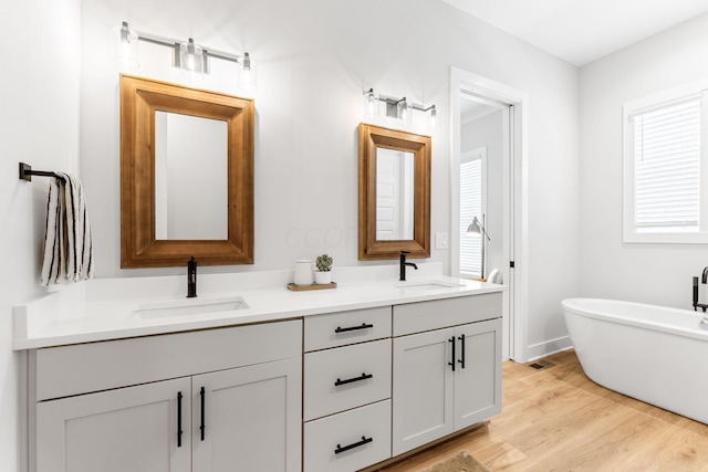 5599 Piatt Rd, Lewis Center, OH 43035 - full bath featuring double vanity, wood finished floors, and a freestanding tub