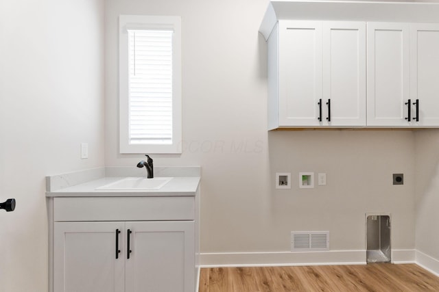 5599 Piatt Rd, Lewis Center, OH 43035 - laundry room with hookup for a washing machine, hookup for an electric dryer, light wood-style floors, and cabinet space