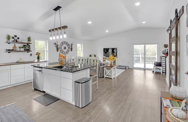 4320 Jacktown Rd, Ostrander, OH 43061 - kitchen featuring a barn door, stainless steel dishwasher, vaulted ceiling, open floor plan, and open shelves