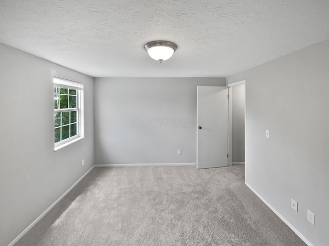 1813 Worthington Run Dr Unit A, Columbus, OH 43235 - empty room with carpet, baseboards, and a textured ceiling