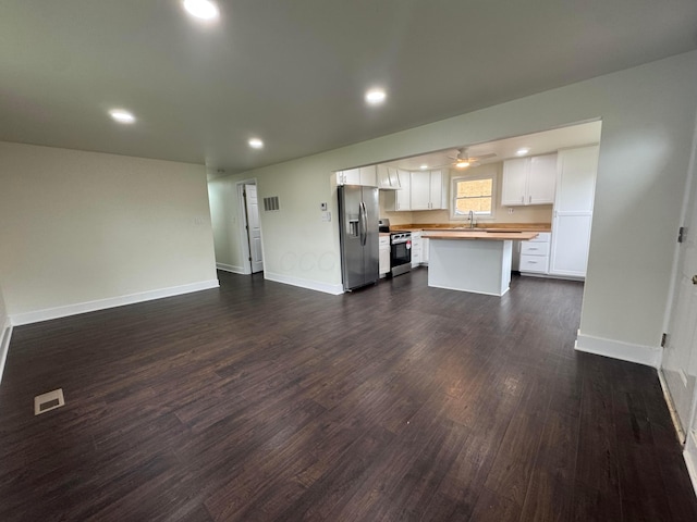 1227 Brown Rd, Columbus, OH 43223 - kitchen with stainless steel appliances, wood counters, recessed lighting, white cabinets, and dark wood-style flooring