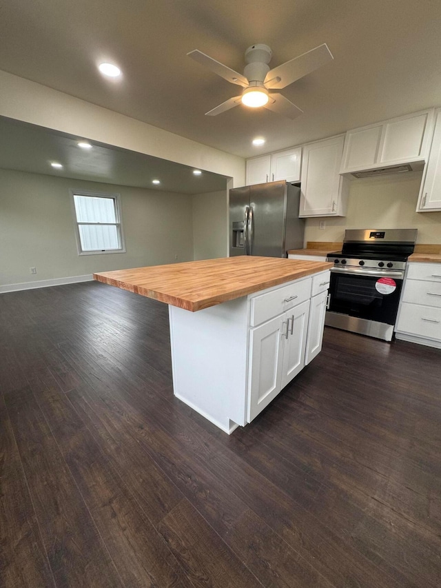 1227 Brown Rd, Columbus, OH 43223 - kitchen with butcher block counters, stainless steel appliances, white cabinets, dark wood finished floors, and recessed lighting