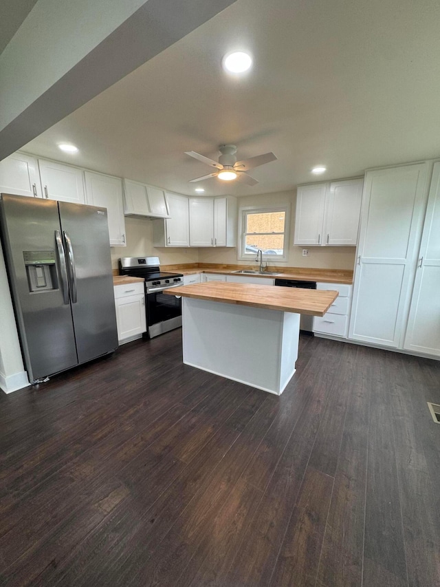 1227 Brown Rd, Columbus, OH 43223 - kitchen with stainless steel appliances, wooden counters, custom exhaust hood, dark wood-style floors, and white cabinets