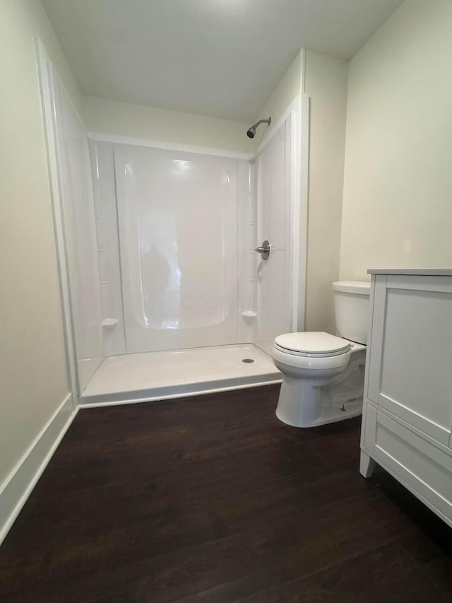 1227 Brown Rd, Columbus, OH 43223 - bathroom featuring a shower, wood finished floors, toilet, and vanity