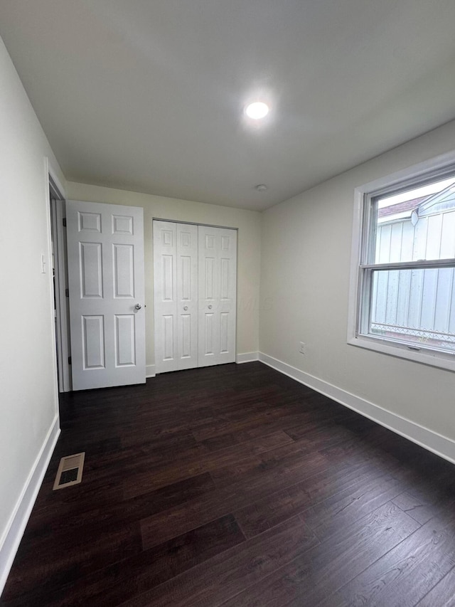 1227 Brown Rd, Columbus, OH 43223 - unfurnished bedroom with baseboards, dark wood-type flooring, a closet, and recessed lighting