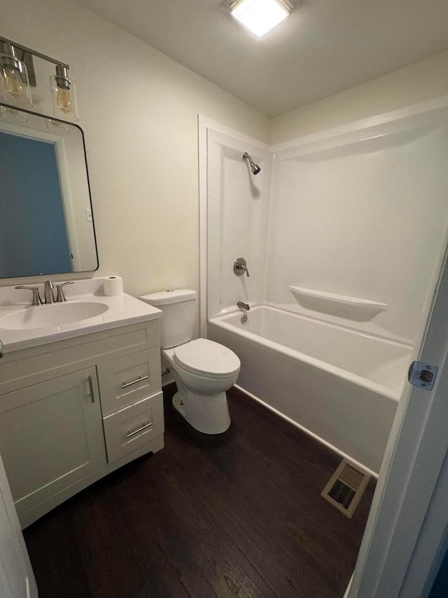 1227 Brown Rd, Columbus, OH 43223 - bathroom featuring wood finished floors, vanity, toilet, and shower / washtub combination