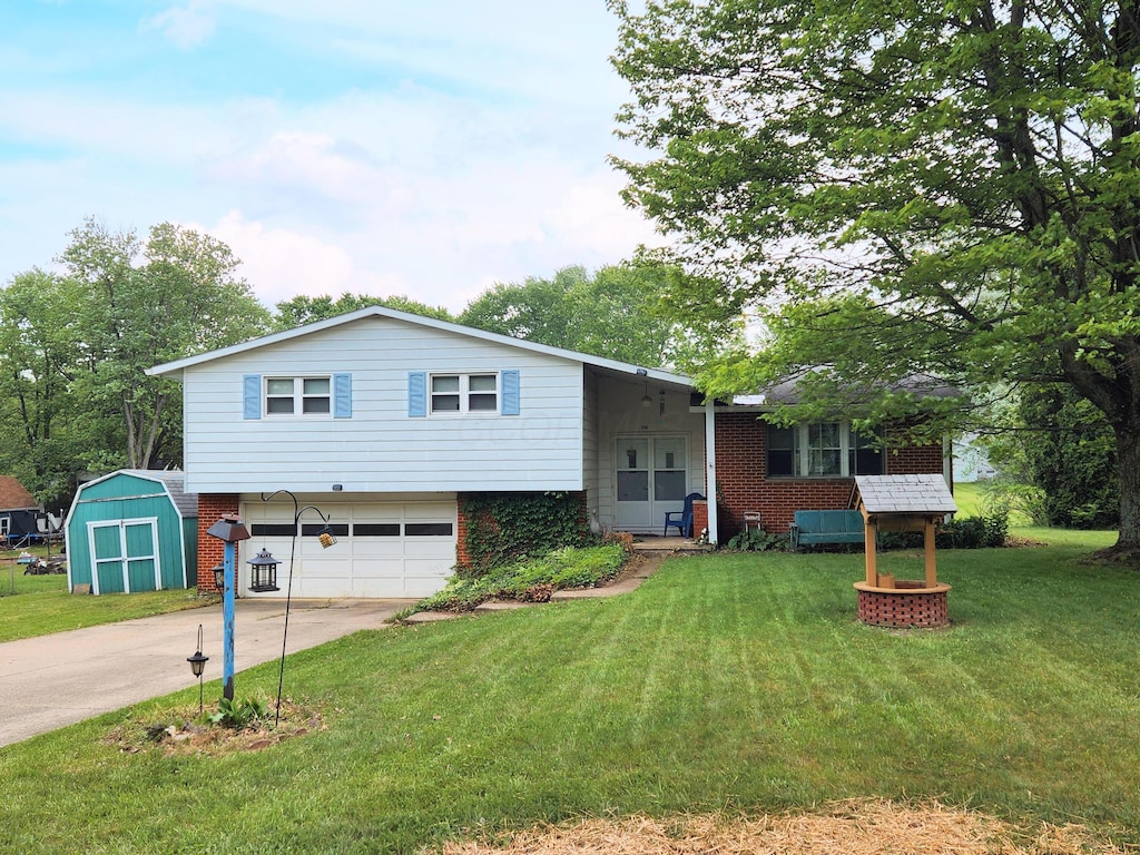 1116 Ramsey Dr, Mansfield, OH 44905 - view of front of property with driveway, a garage, a front lawn, and a shed