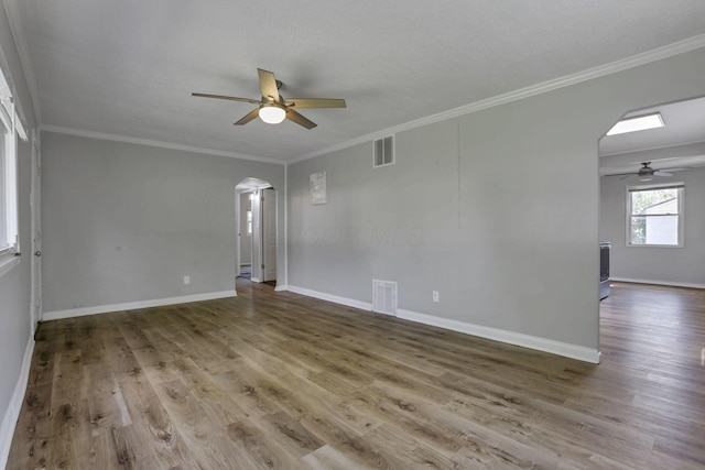 392 S Hampton Rd, Columbus, OH 43213 - spare room featuring arched walkways, a ceiling fan, wood finished floors, ornamental molding, and baseboards
