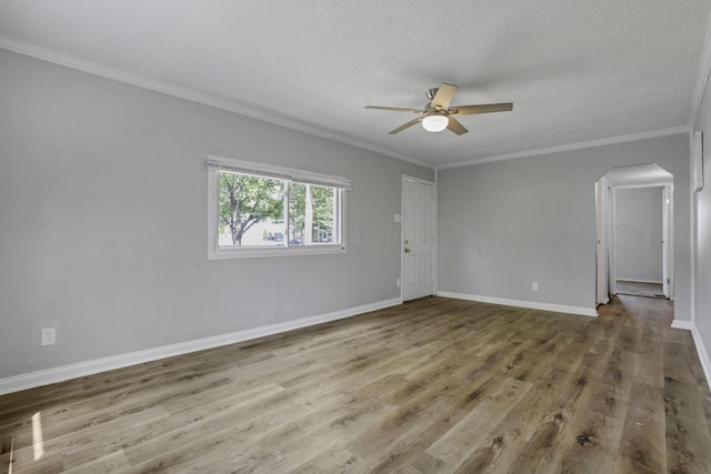 392 S Hampton Rd, Columbus, OH 43213 - empty room with a ceiling fan, arched walkways, wood finished floors, a textured ceiling, and ornamental molding