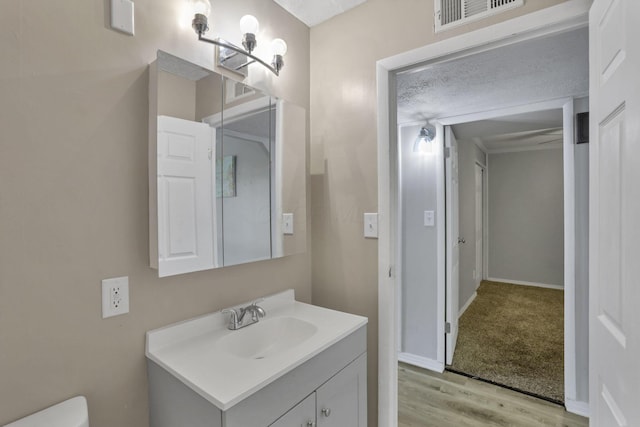 392 S Hampton Rd, Columbus, OH 43213 - half bathroom with wood finished floors, vanity, toilet, and baseboards
