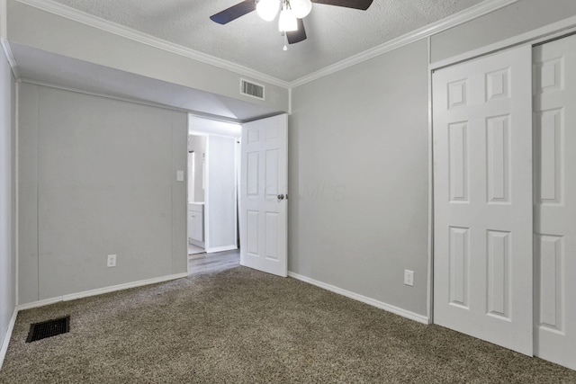 392 S Hampton Rd, Columbus, OH 43213 - unfurnished bedroom with dark carpet, baseboards, a textured ceiling, ornamental molding, and a closet