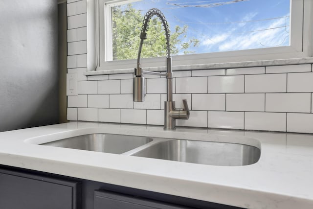 3197 E Ave, Columbus, OH 43207 - kitchen view of a sink, backsplash, and light stone countertops