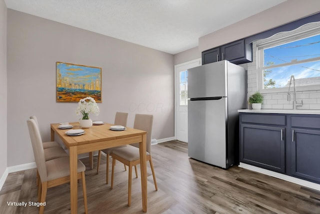 3197 E Ave, Columbus, OH 43207 - dining room featuring baseboards and wood finished floors